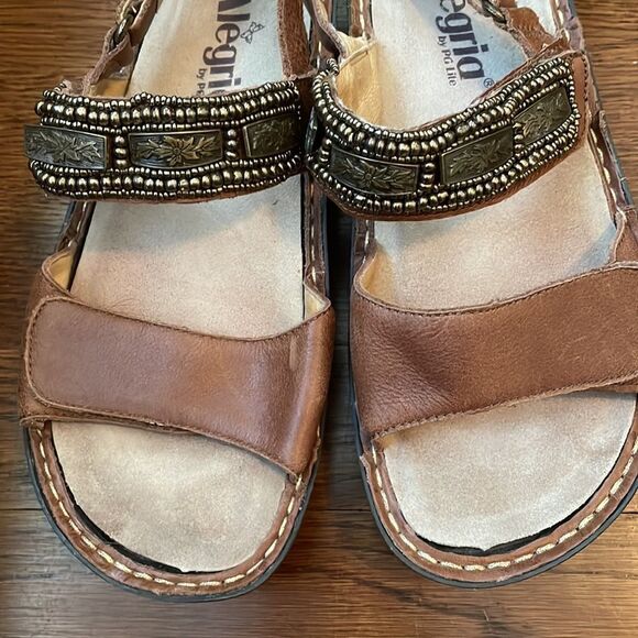 Alegria
by PG Lite brown leather Velcro strap sandals with bronze details on top - Picture 2 of 9
